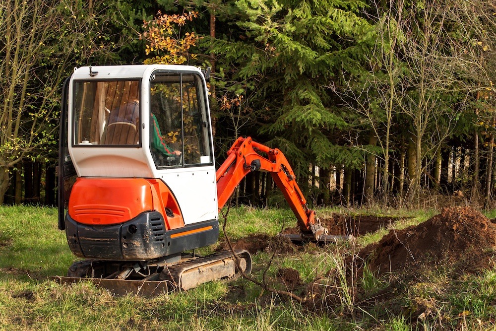 man working with a mini digger